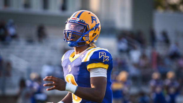 Nate White running into the end zone with the football for Rufus King High School.